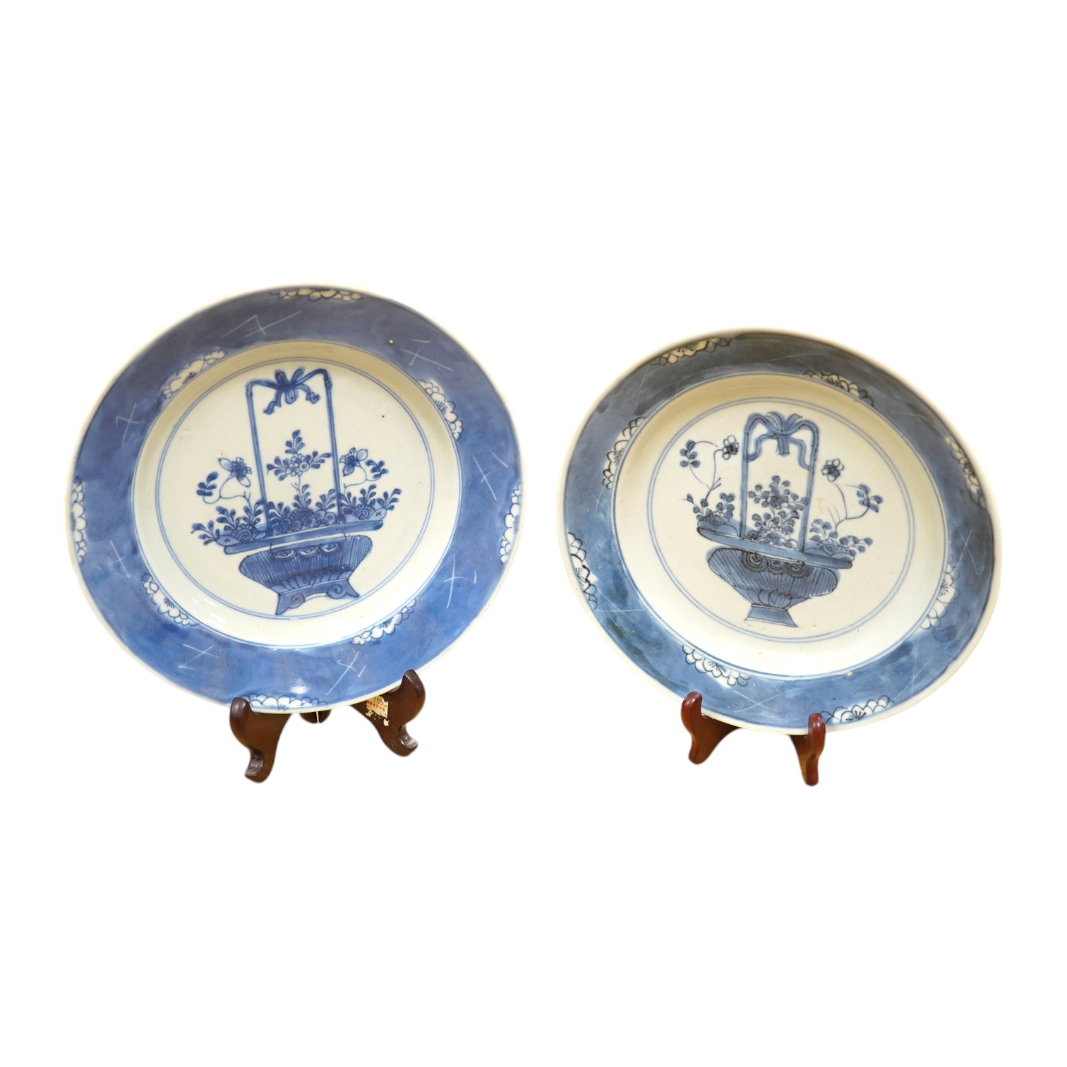 A near pair of 18th century Chinese blue and white 'basket' plates, ring marks to the bases, 20cm in diameter. Condition - good, minor chipping